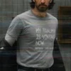 Man wearing a grey t-shirt reading My Trauma Is Vintage Now, shot with glitch-like distortion.